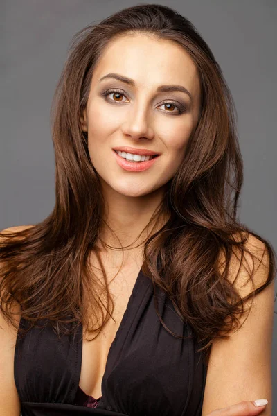 Beautiful brunette woman in black dress — Stock Photo, Image