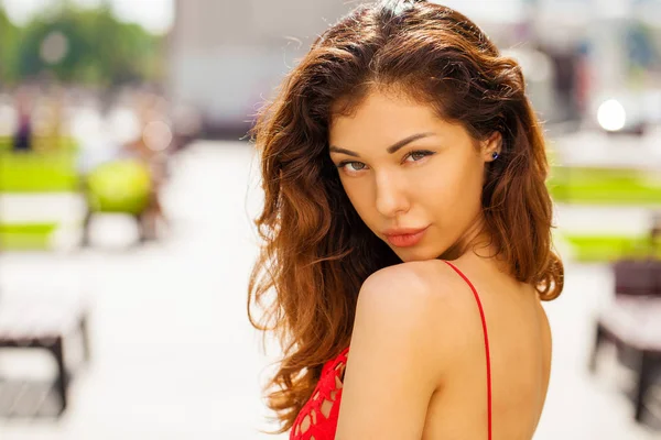 Beautiful brunette woman in sexy red dress — Stock Photo, Image