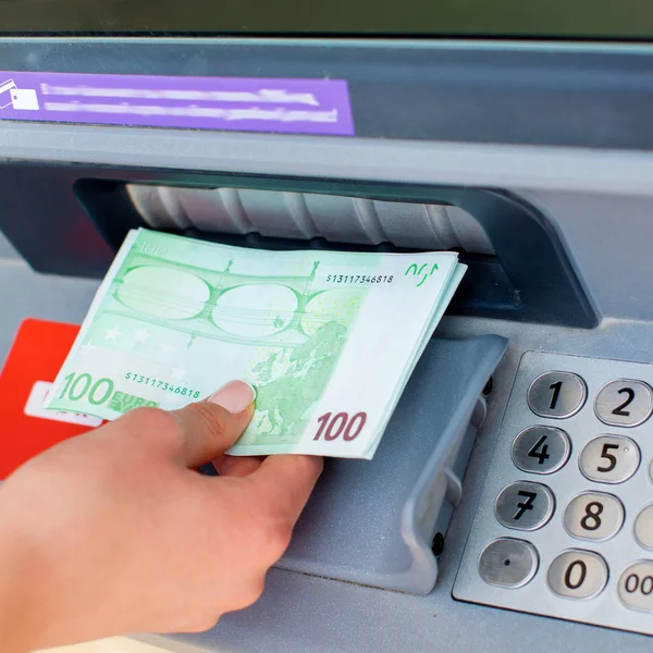 Woman hand withdrawing money from outdoor bank ATM — Stock Photo, Image