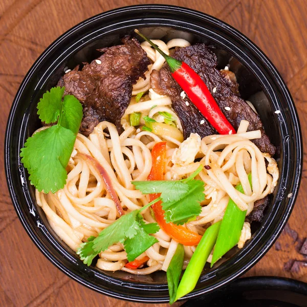 Restaurant dish noodles with bits of beef