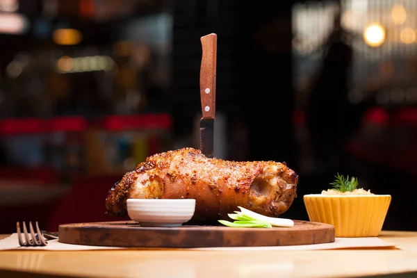 Ресторан блюдо - большой запеченный свиной сустав на деревянном подносе — стоковое фото