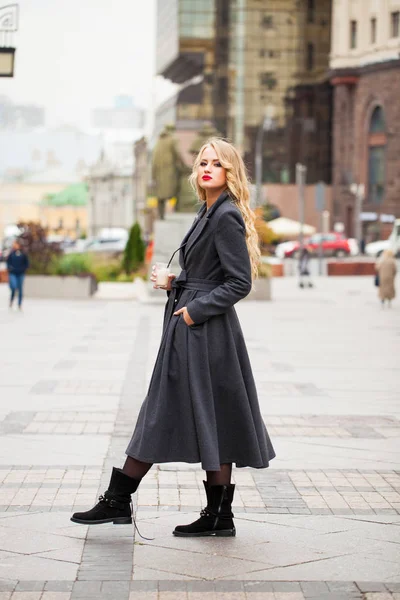 Portrait of a young beautiful woman in gray coat — Stock Photo, Image