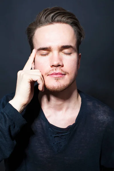 Studio portrait of young man on a dark background — Stock Photo, Image