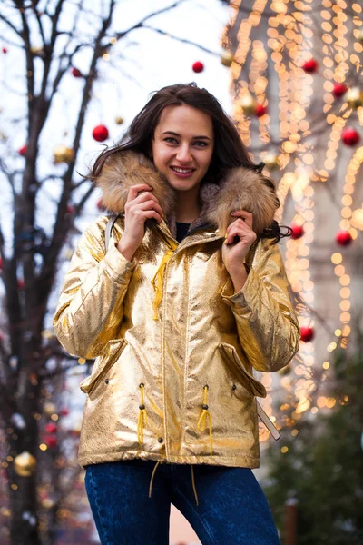 Young beautiful woman in golden jacket — Stock Photo, Image