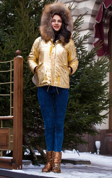 Young beautiful woman in golden winter coat — Stock Photo, Image