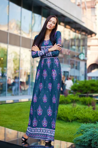 Beautiful young woman in colorful dress — Stock Photo, Image