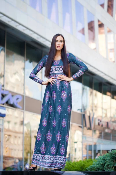 Beautiful young woman in colorful dress — Stock Photo, Image