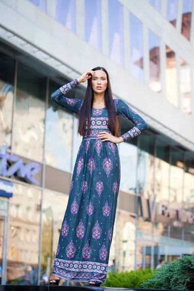 Beautiful young woman in colorful dress — Stock Photo, Image