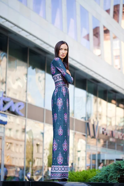 Beautiful young woman in colorful dress — Stock Photo, Image