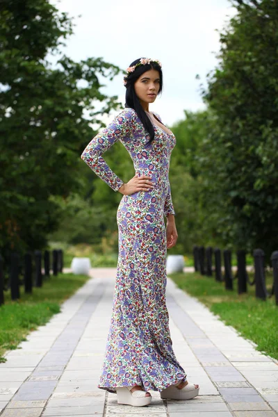 Beautiful young woman in colorful dress — Stock Photo, Image