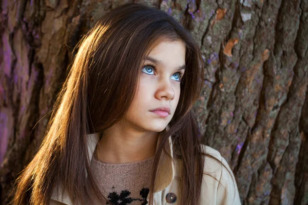 Happy young little girl in beige coat — Stockfoto