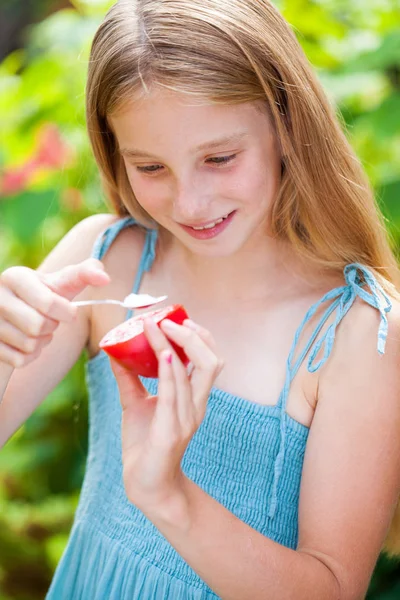 Portrait of a little girl with red tomato — Stockfoto