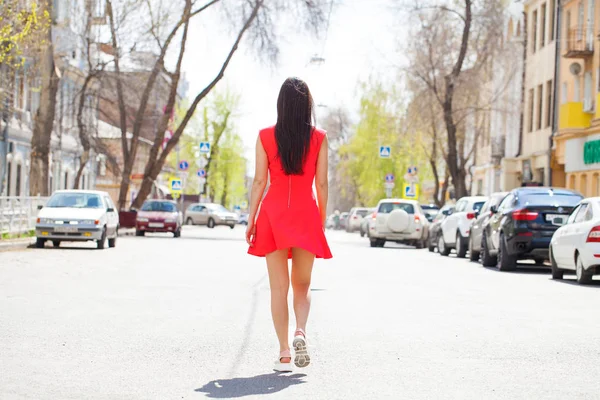 Young beautiful woman in red dress on the summer street — Stock Photo, Image