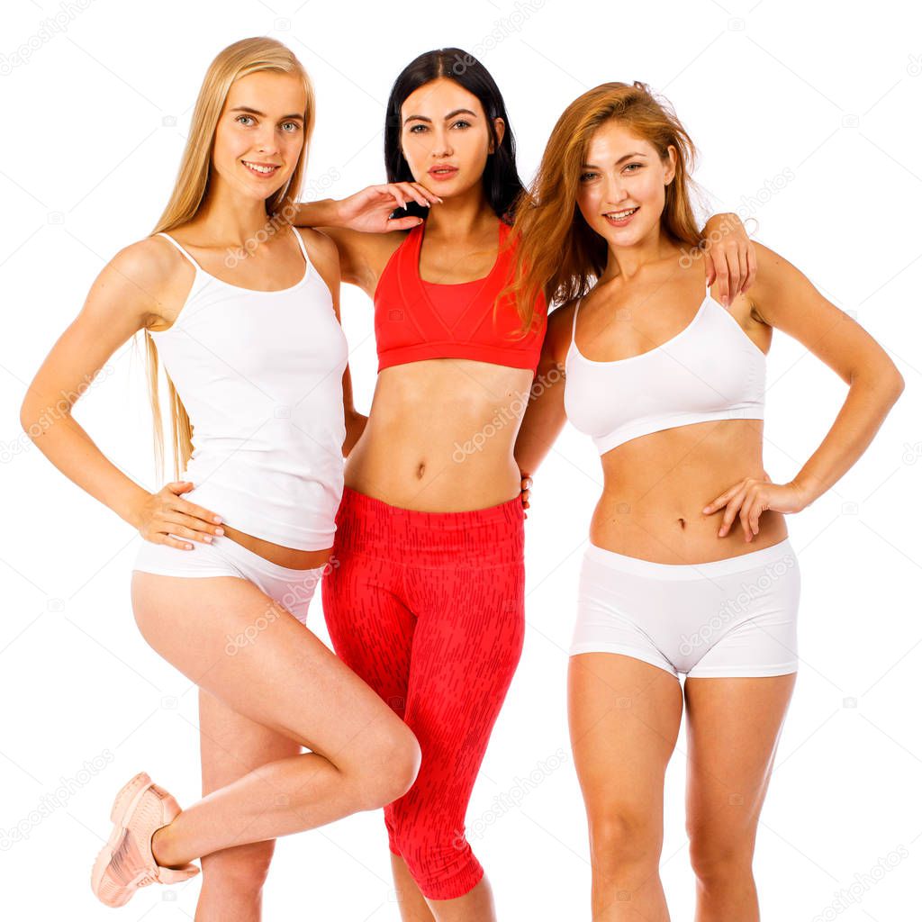 Fitness women. Young beautiful girlfriends in white sportswear