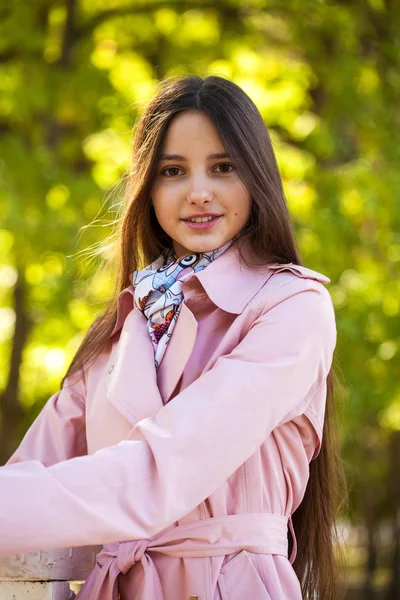 Portrait of a young beautiful woman in pink coat — Stock Photo, Image