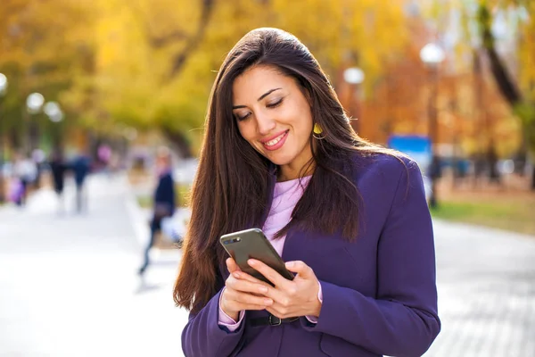 Portrait of a young beautiful model calling by smart phone — Stock Photo, Image