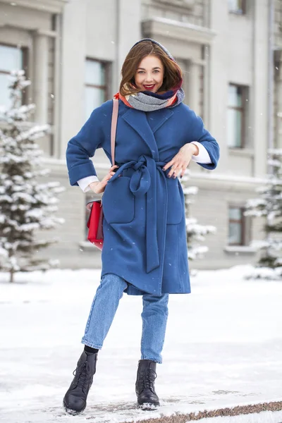 Portrait of young girl in blue jeans walking in a winter park — 스톡 사진