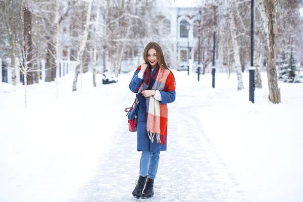 Portrét mladé dívky v modrých džínách procházky v zimním parku — Stock fotografie