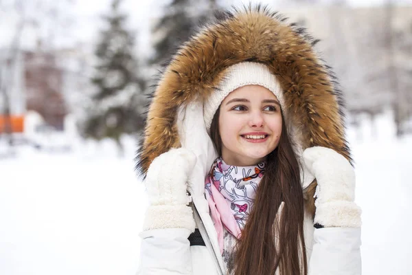 Close up portrait of a young beautiful girl with a fur hood — 스톡 사진