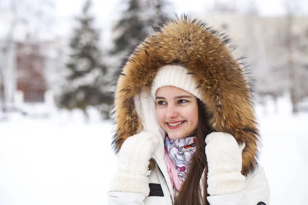 Close up portrait of a young beautiful girl with a fur hood — Stock Photo, Image