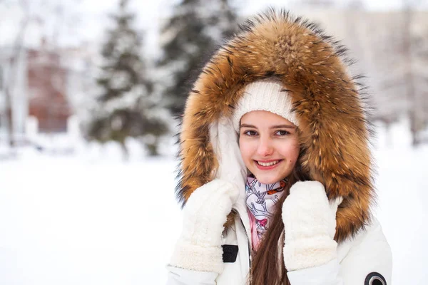 Close up portrait of a young beautiful girl with a fur hood — Stock Photo, Image