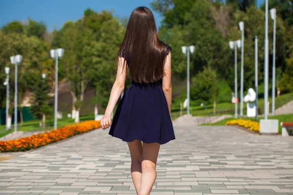 Jeune belle femme en robe bleue marchant dans la rue d'été — Photo