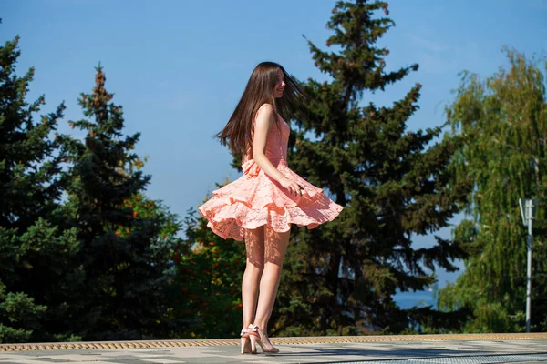 Jovem mulher bonita em vestido rosa andando na rua de verão — Fotografia de Stock