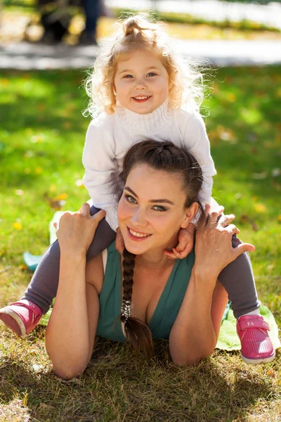 Closeup portrait of a young beautiful mother with little curly d — Stock Photo, Image