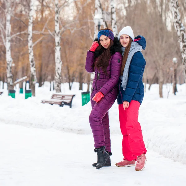 Portrait of two young beautiful women in ski suit posing in wint — 스톡 사진