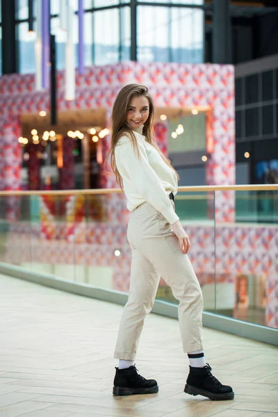 Portrait of a young beautiful woman in beige sweater and pants p — 스톡 사진