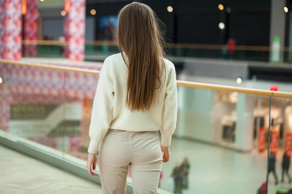 Portrait of a young beautiful woman in beige sweater and pants p — Stock Photo, Image