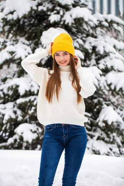 Young beautiful woman in a woolen sweater posing on a background — Stock Photo, Image