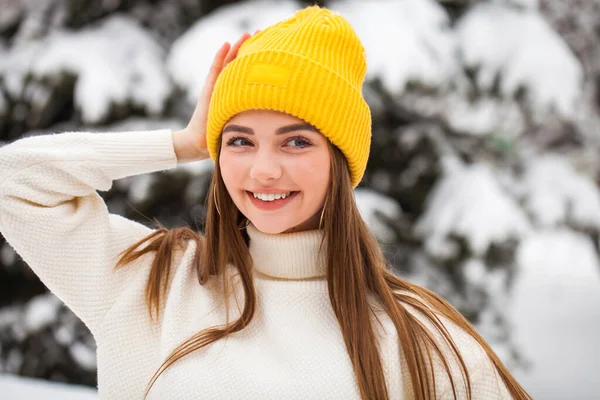 Young beautiful woman in a woolen sweater posing on a background — Stock Photo, Image