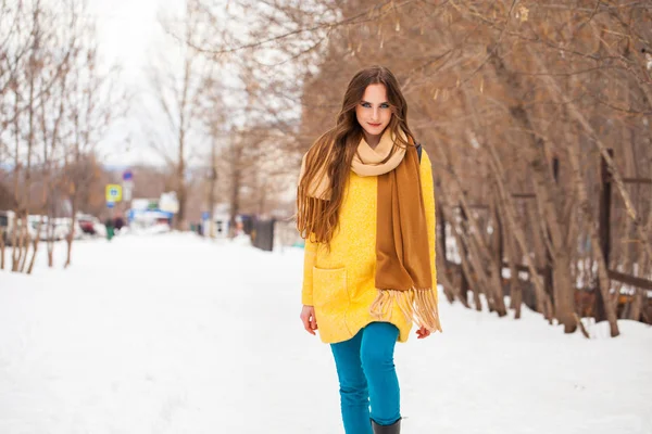 Joven hermosa mujer en abrigo amarillo caminando parque de invierno — Foto de Stock