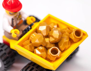 RUSSIA, SAMARA, FEBRUARY 15, 2020 - Lego City Minifigures Miner on a cart carries gold mined clipart