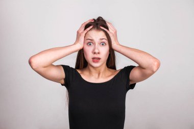 Gri arka planda izole edilmiş güzel esmer bir modelin yakın portresi.