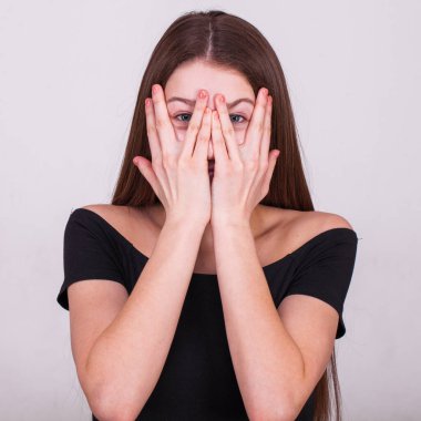 Gri arka planda izole edilmiş güzel esmer bir modelin yakın portresi.