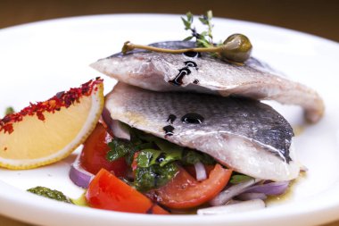 Restoran gıda - Dorado ızgara balık beyaz tabakta soğan ve limon dilimi ile