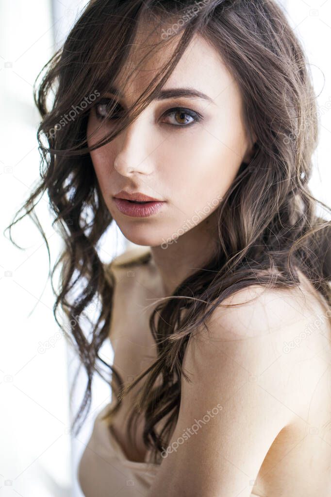 Close up portrait of a young beautiful brunette model in studio