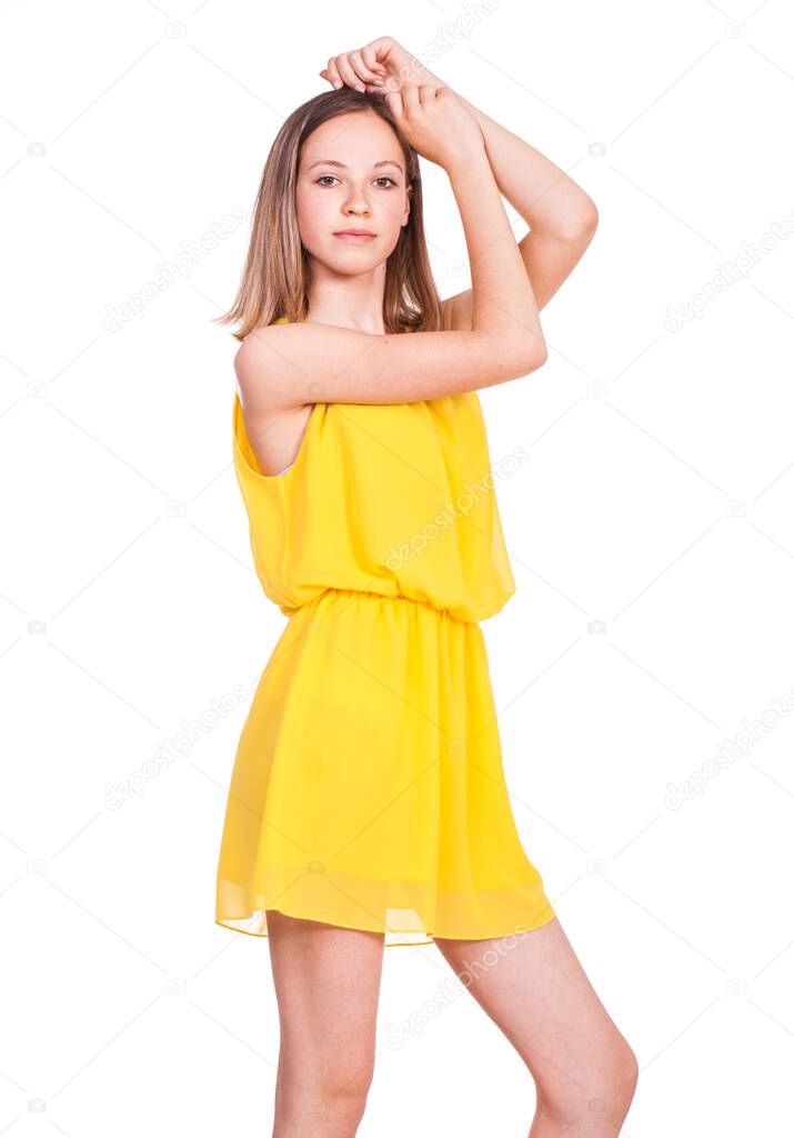 Close up portrait of a young beautiful blonde model in yellow dress, isolated on white background