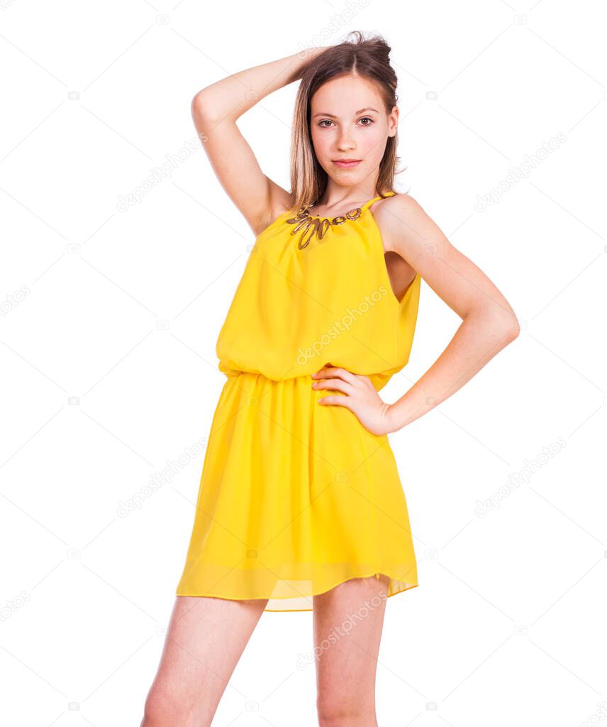 Close up portrait of a young beautiful blonde model in yellow dress, isolated on white background