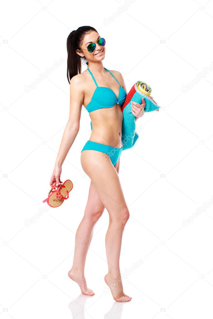 Beautiful brunette woman in turquoise swimsuit with Beach towel, isolated on white background