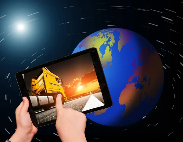 Hands holding tablet with truck on screen — Stock Photo, Image