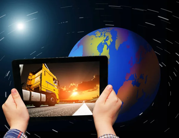 Hands holding tablet with truck on screen — Stock Photo, Image