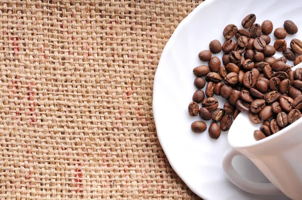 Spilled coffee beans from cup