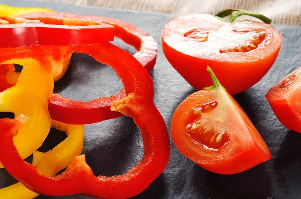 Sliced tomato with bell pepper rings
