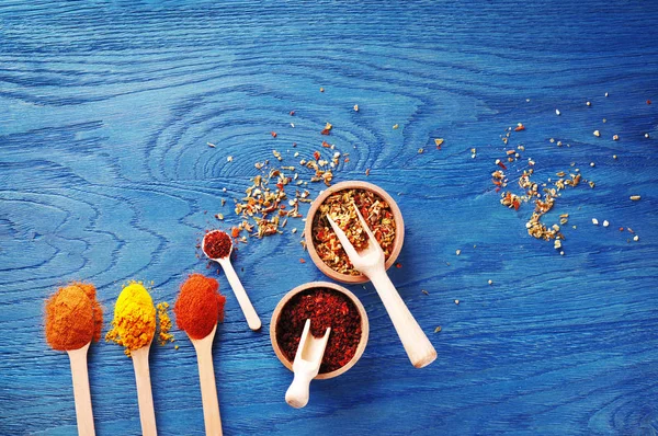 Spices in wooden bowls with spoons — Stock Photo, Image