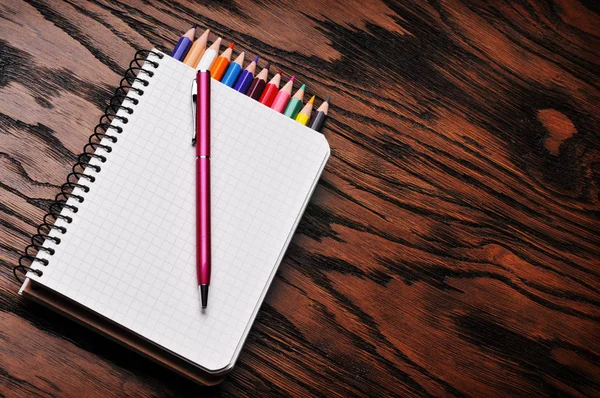 An opened notebook with pencils — Stock Photo, Image