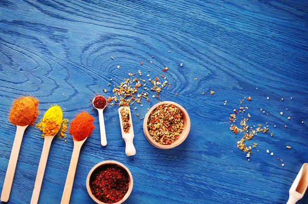 Top View Different Dry Spices Wooden Bowls Spoons Dark Blue — Stock Photo, Image