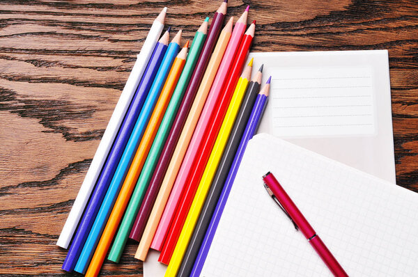 School copybook and a notebook with color pencils